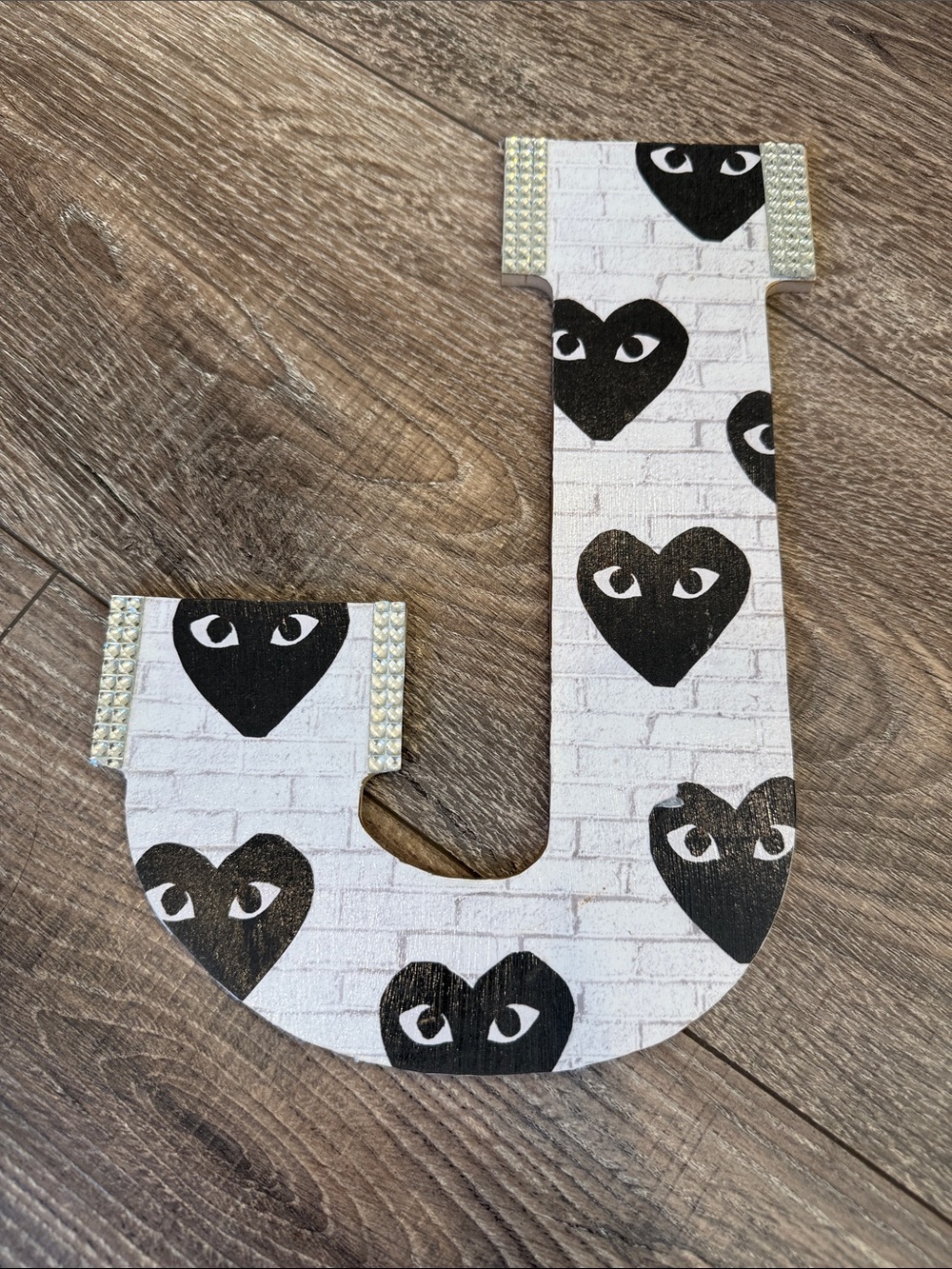 Decorative Letter J with Black Heart Eyes Pattern